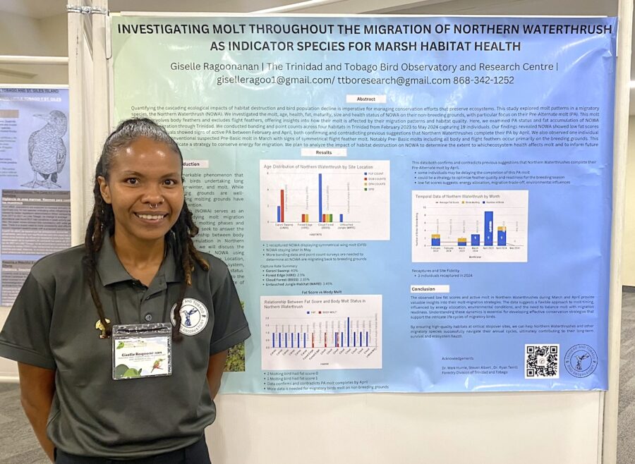 Woman standing in front of and to the left of a scientific poster. 